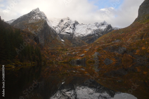 Autumn colors and reflections in the Norwegian fjords and mountains over Lofoten, Norway © ChrisOvergaard