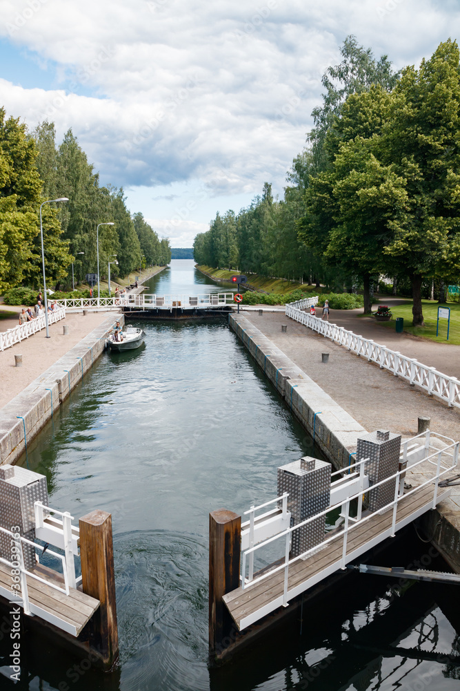 Fototapeta premium Asikkala, Finland - 16 July 2020: Vaaksy Canal between two big lakes Vesijarvi and Paijanne. Gateway is open for boats going though.