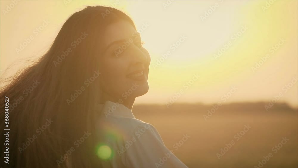 Close up portrait pretty woman in stylish cloth walking in field and spinning around at sunset with charming smile. Happy and successful lifestyle concept Close up portrait pretty woman in stylish cloth walking in field and spinning around at sunset with charming smile. Happy and successful lifestyle concept