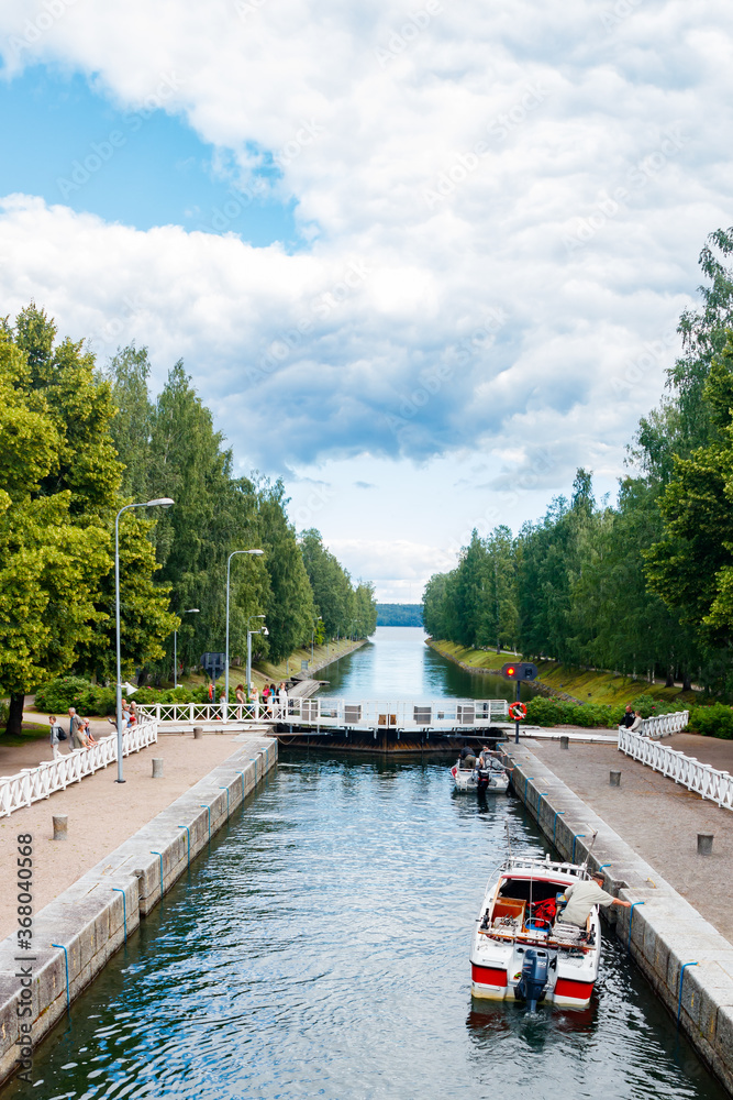Fototapeta premium Asikkala, Finland - 16 July 2020: Vaaksy Canal between two big lakes Vesijarvi and Paijanne. Gateway is open for boats going though.