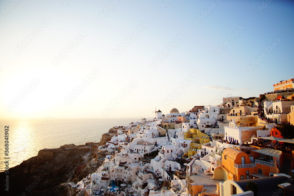Sunset shines beautiful town of Santorini island, Greece, Europe