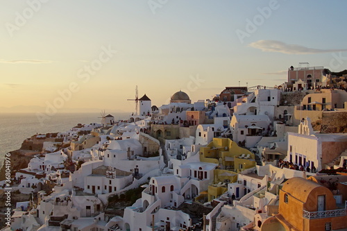 Sunset shines beautiful town of Santorini island, Greece, Europe