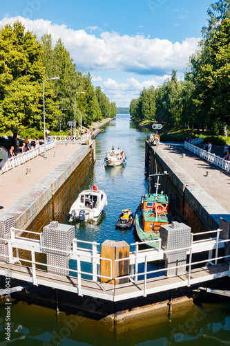 Asikkala, Finland - 16 July 2020: Vaaksy Canal between two big lakes Vesijarvi and Paijanne. Gateway is open for boats going though. photo