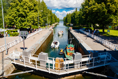 Asikkala, Finland - 16 July 2020: Vaaksy Canal between two big lakes Vesijarvi and Paijanne. Gateway is open for boats going though. photo