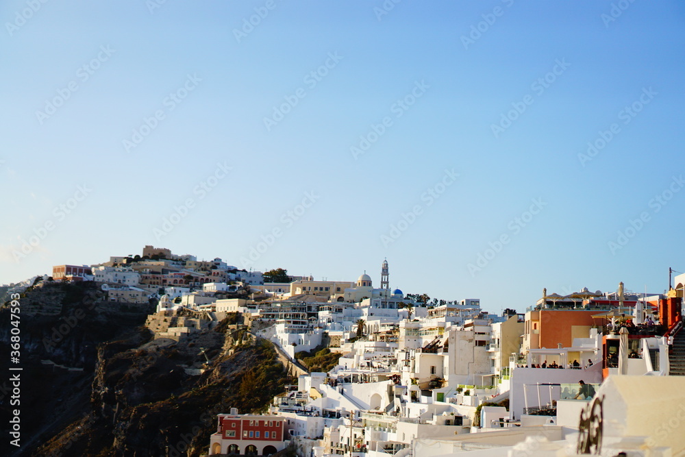 The sunset into the sea, seeing from beautiful city, Thira, Greece, Europe