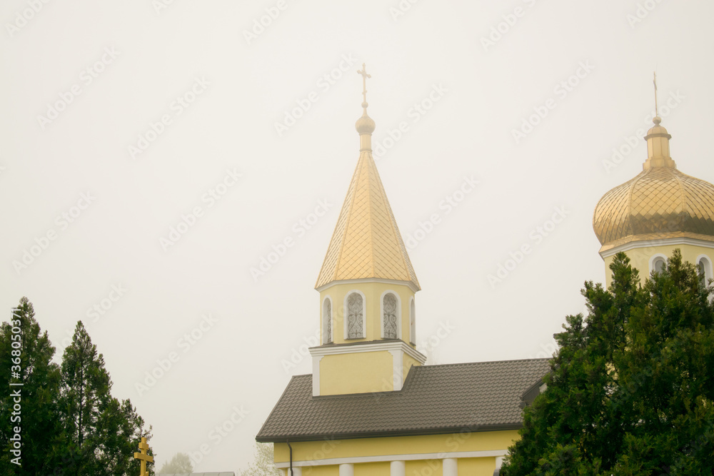 Orthodox church with golden domes on a cloudy day close-up. Religion concept Orthodox church with golden domes on a cloudy day close-up. Religion concept