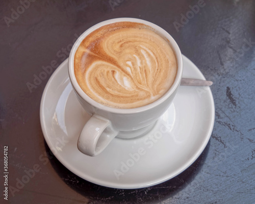 Italian cappuccino coffee cup on wooden table surface
