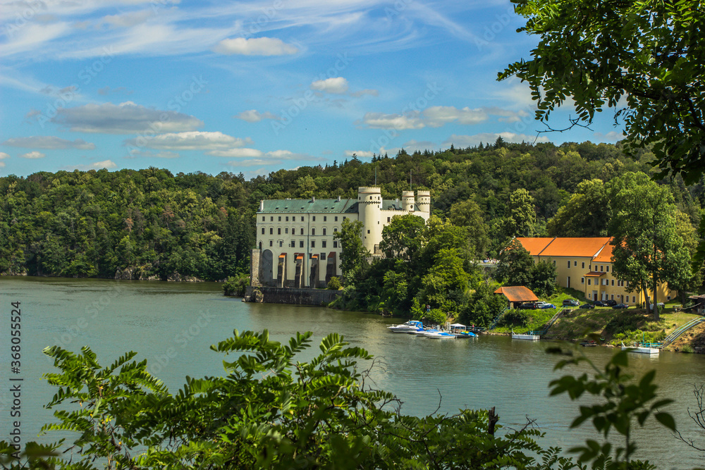 View of Orlik Castle, must see in the Czech Republic.Famous tourist place on a rock above Vltava river.Beautiful summer landscape with Orlík Water Reservoir and boats.Travel background space for text