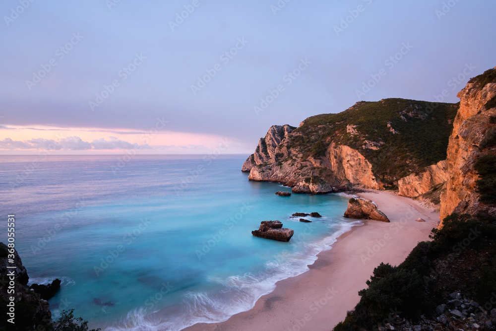 Wide angle shot at dawn of the Ribeira do Cavalo beach in Sesimbra, Portugal.