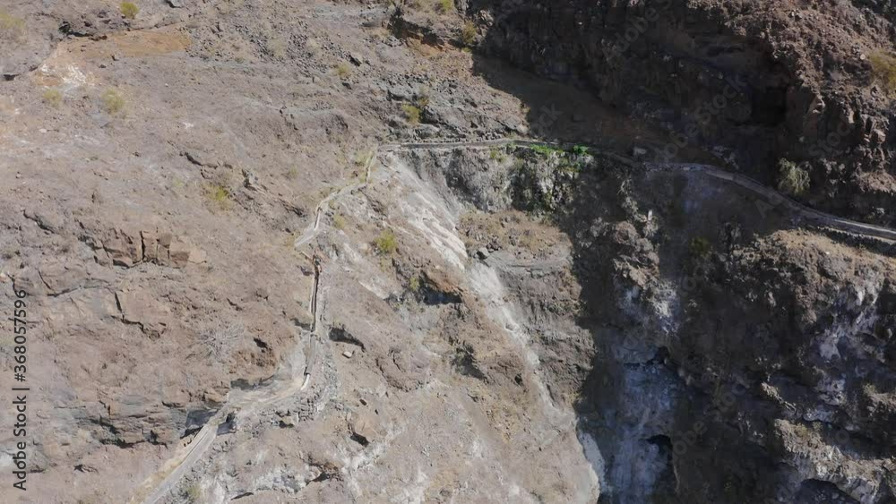 Drone aerial view of extreme hiking in Gorge Masca Mountains in Tenerife, Canary Islands Drone aerial view of extreme hiking in Gorge Masca Mountains in Tenerife, Canary Islands