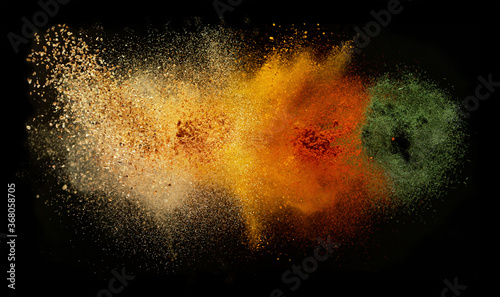 Freeze motion of spice explosion, black background photo