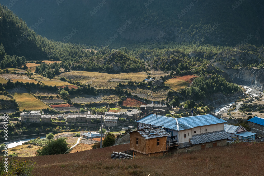 Naklejka premium Lower and Upper Pisang villages with Marshyangdi river in between, separating them, Around Annapurna trek, Manang village, Gandaki district, Nepal Himalayas, Nepal