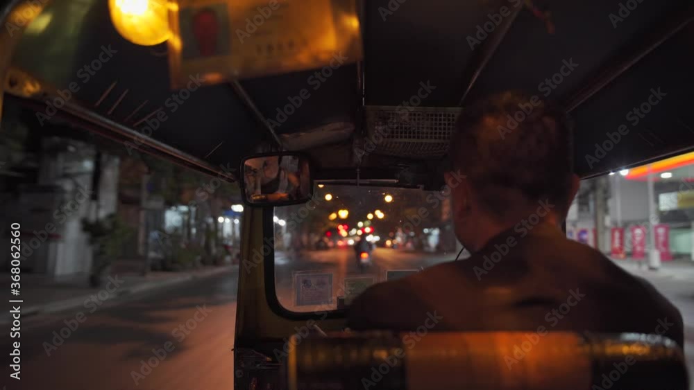 View from inside a TUK TUK taxi driving through streets of Bangkok at night, Thailand View from inside a TUK TUK taxi driving through streets of Bangkok at night, Thailand