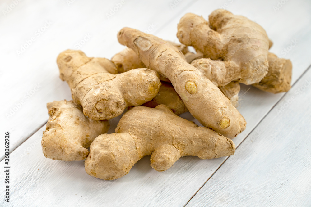 ginger root on white wooden background ginger root on white wooden background