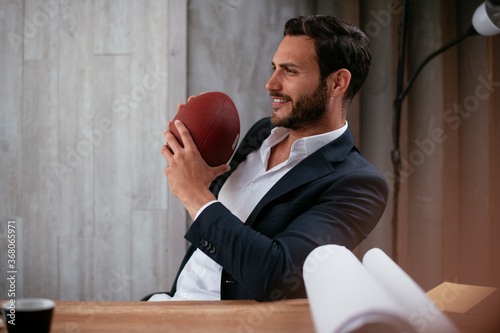 Handsome businessman working on projects. Young man having fun while working.