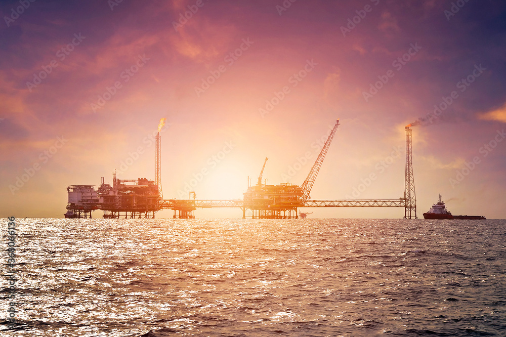 Offshore construction platform for production oil and gas in gulf of Thailand with sunset sky