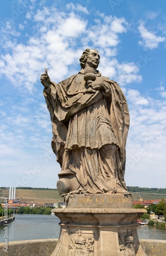 Low angle vertical shot of a statue from Old Main Bridge located in Wurzburg, Germany photo