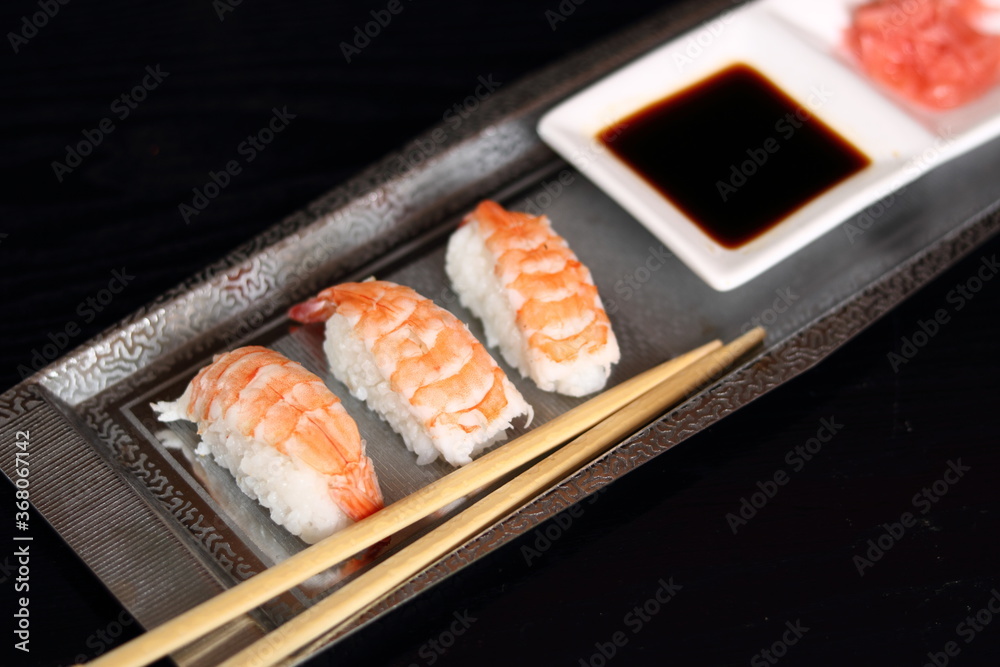 Sushi nigirizushi with soy sauce and gari on metal tray with chopsticks Sushi nigirizushi with soy sauce and gari on metal tray with chopsticks