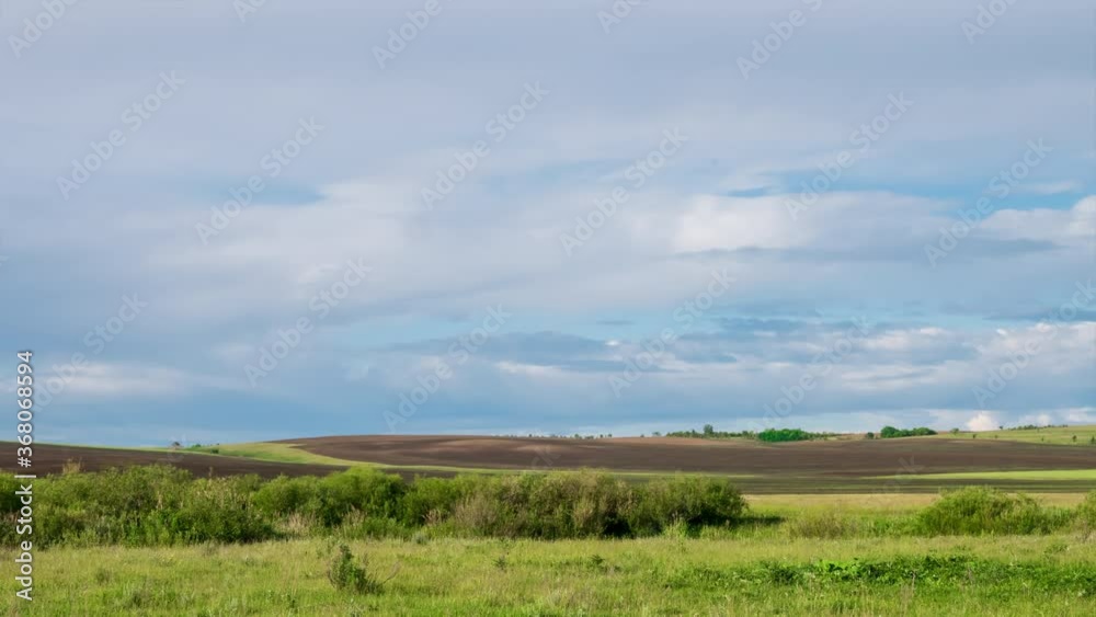Timelapse of scenic landscape. Amazing clouds in the blue sky over the fields Timelapse of scenic landscape. Amazing clouds in the blue sky over the fields