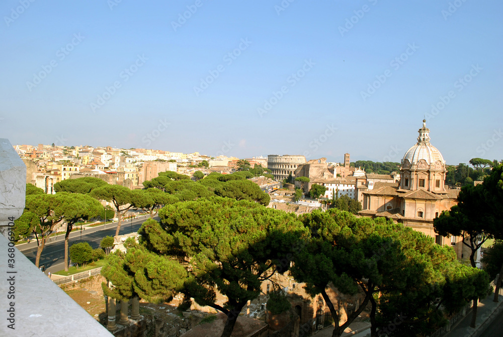 Panoramic view on Rome city complete with the Roman forum the church Chiesa dei Santi Luca e Martina and the Colosseum from the Vittorio Emanuele II Monument also known as the Vittoriano.