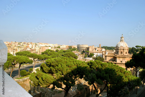 Panoramic view on Rome city complete with the Roman forum the church Chiesa dei Santi Luca e Martina and the Colosseum from the Vittorio Emanuele II Monument also known as the Vittoriano.
