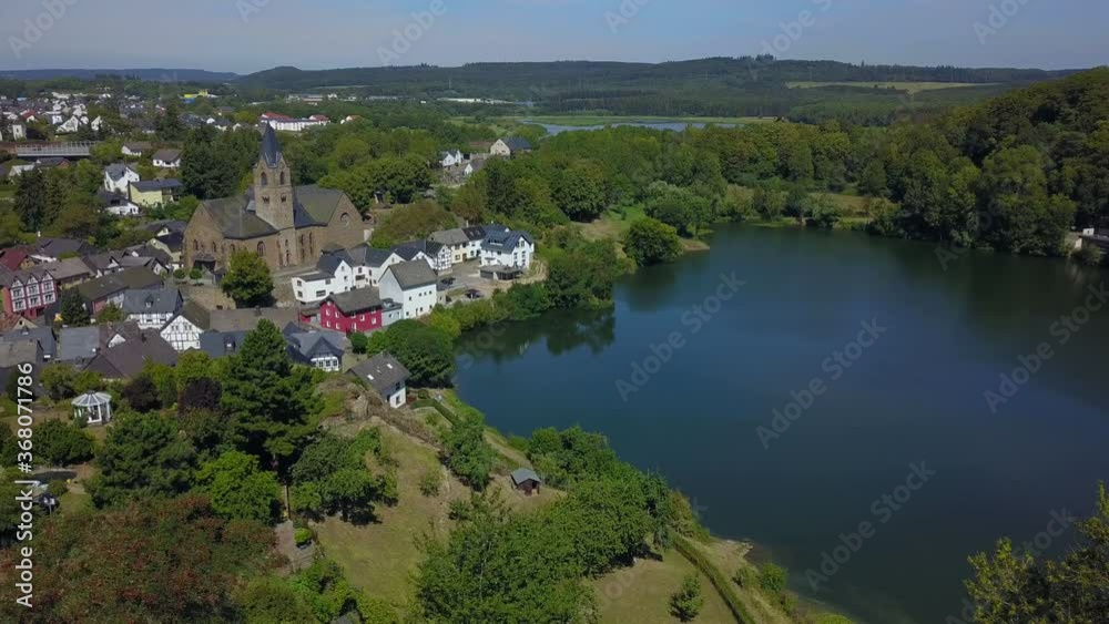 Ulmen (Ulmener) Maar with Parish Church of St. Matthew, Ulmen, Eifel, Rhineland-Palatinate, Germany Ulmen (Ulmener) Maar with Parish Church of St. Matthew, Ulmen, Eifel, Rhineland-Palatinate, Germany