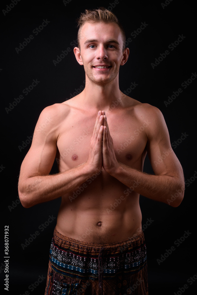 Obraz premium Portrait of young handsome shirtless man with blond hair
