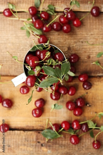 Ripe red cherries in an iron cup