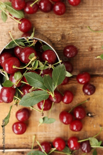 Ripe red cherries in an iron cup