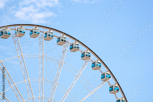Close up Giant Ferris Wheel in Hong Kong near Victoria Harbor with clear sky background,Hong Kong © ChomchoeiFoto