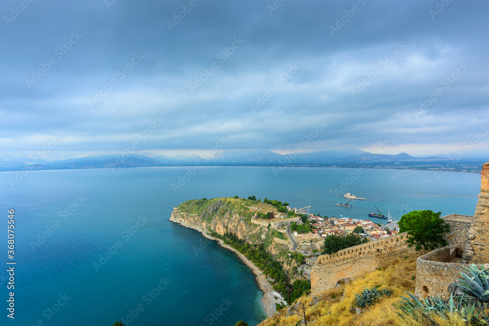 View of the cape, port, the historical part of the city of Nafplion and the island of Bourtzi from the height of the walls of the Themistoklis bastion of Palamidi fortress. Nafplion, Greece