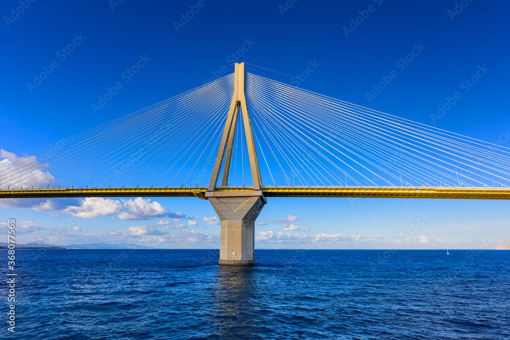 Obraz premium The Rion-Antirion Bridge connects the Peloponnese Peninsula with mainland Greece, this Cable-stayed road bridge with pedestrian sidewalks over the Gulf of Corinth, Greece