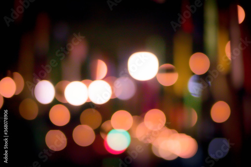 Blur the lights on the restaurant. Blurred cafe background with bokeh. orange ,red, light, blue, green, pink. © Nanthicha Khamphumee