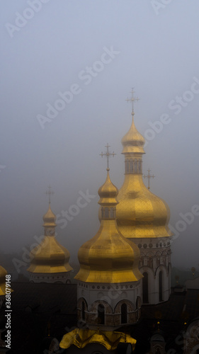 Kiev, Ukraine - Foggy view of golden domes in an ancient Ukrainian monastery. Concept photo with a religious theme.