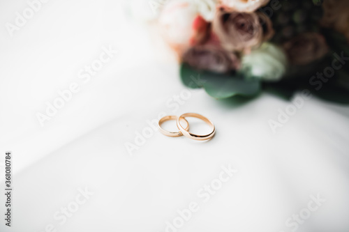 Two golden wedding rings isolated background concept