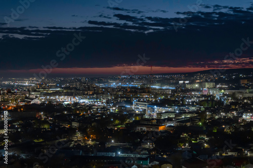 Multi-colored (blue and orange colors) sunset on the city of Saratov. View from the observation deck to the night city.
