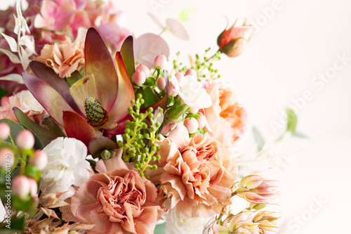 Autumn composition made of beautiful flowers on light backdrop. Floristic dec...