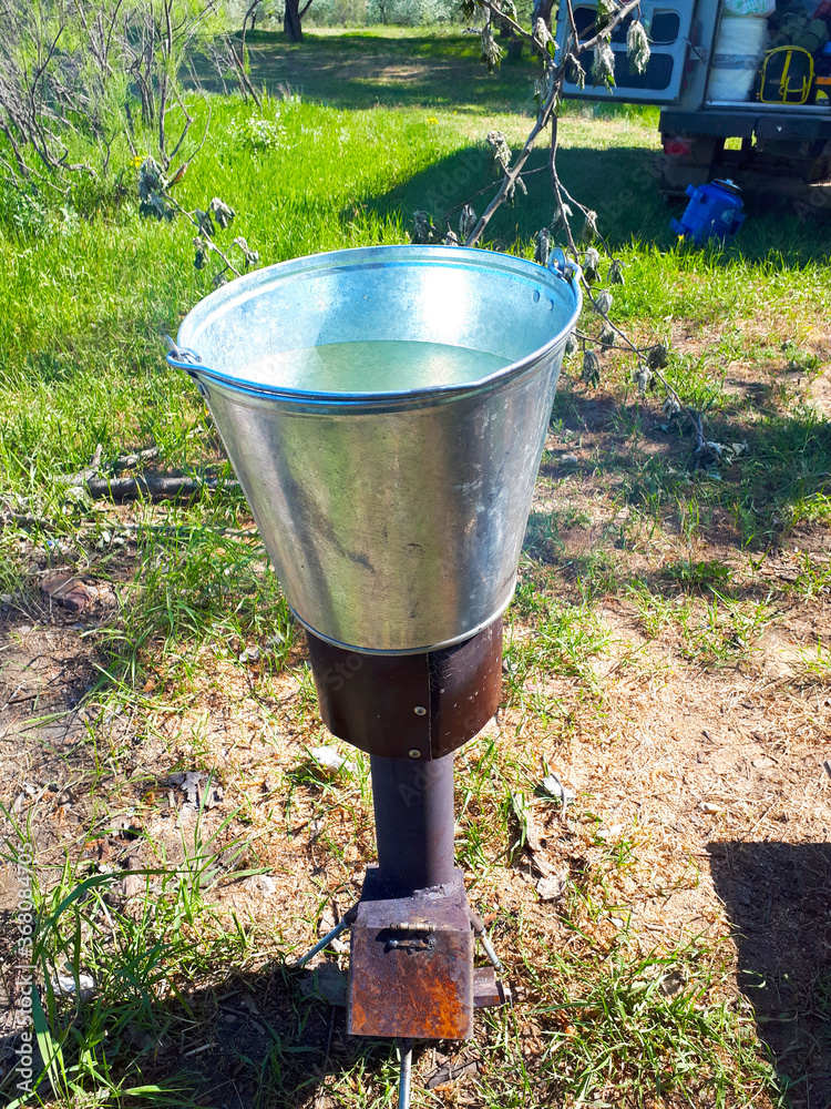 An aluminum bucket of warm water on a tourist stove.
An aluminum bucket of warm water on a tourist stove.