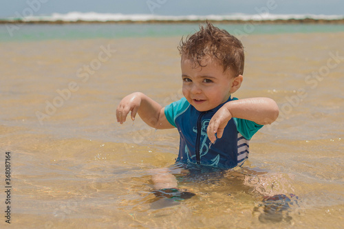 playing on the shallow golden beach in la posita beach in puerto rico  photo