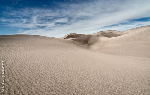 Sand dunes against blue sky