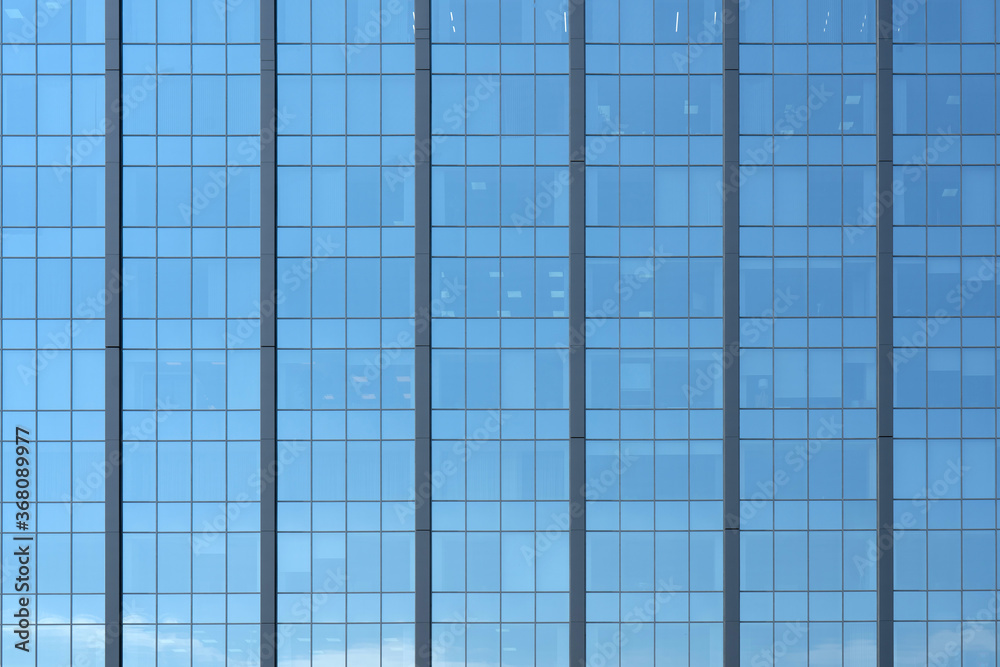 Glass windows of a modern building. Facade of an office building. Glass windows of a modern building. Facade of an office building.