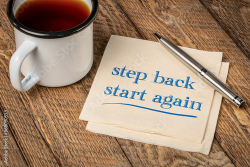 step back, start again motivational note - handwriting on a napkin with a cup of tea, persistence and determination concept photo
