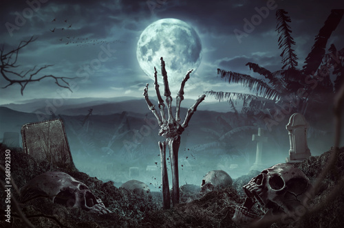 Canvas Print Zombie skeleton hand rising in dark Halloween night.