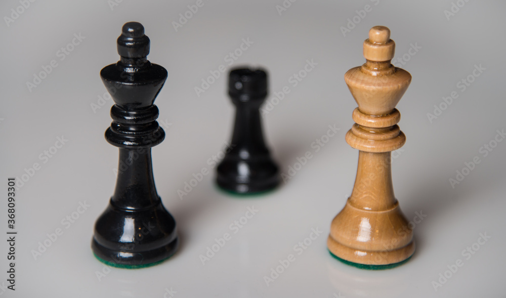 Chess pieces on a wooden board. The concept of tactical games.
