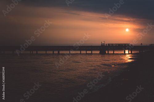 The jetty at Hamble linking to the Fawley Oil Refinery in Hampshire, UK. A sunset shot of beautiful nature and man-made industry