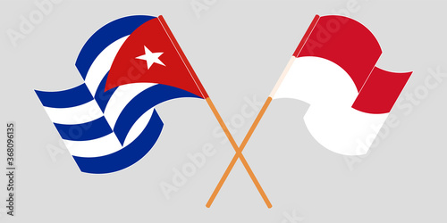 Crossed and waving flags of Cuba and Indonesia