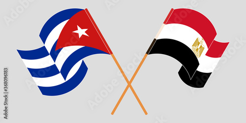 Crossed and waving flags of Cuba and Egypt