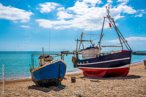 Fishing vessels pulled up onto the shingle beach at Hastings  Sussex  UK in summer