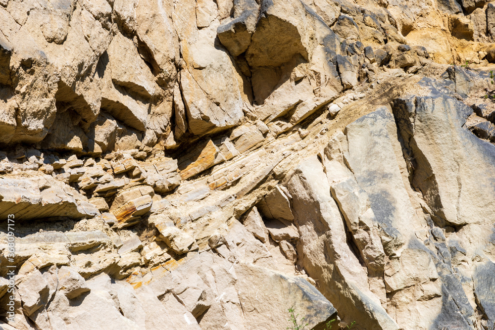 Texture rock surface background. Limestone material wall in nature. Steep slope. Jozefow quarry. Poland, Europe. Texture rock surface background. Limestone material wall in nature. Steep slope. Jozefow quarry. Poland, Europe.
