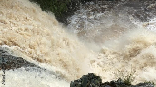 A river in North Wales flows fast after a heavy rainfall